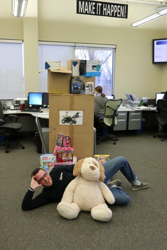 Nate poses with toy drive gift Challenger